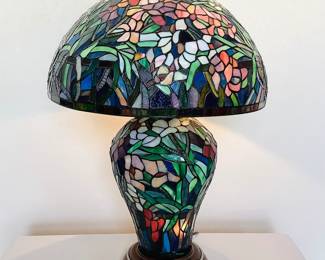 Stained glass lamp which features (3) light settings. Powers on. Excellent condition. No manufacturer found. H 27" x 16" diameter.