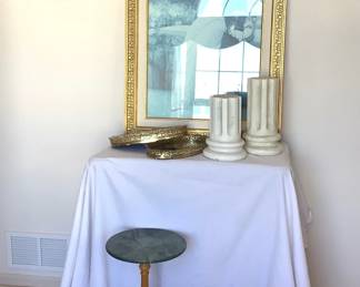 Impressionist home accents including a framed print of a woman holding a butterfly H 42" x W 27", a marble topped table H 21", (2) column style candles H 10" and H 12" and (2) mirrored filigree vanity trays.
