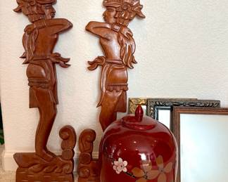 Pair of Honduran folk art wood carvings, H 28" x W 8 1/2". Maroon vase featuring a floral design and lid. H 13" x 8' diameter. Made in China