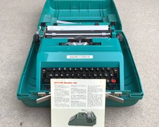 Vintage Olivetti typewriter. Includes storage/carrying case and instruction manual. Model "Studio 45".