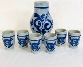 Salt glazed stoneware drinking set which includes a pitcher H 8" x 5" diameter and (6) water/juice glasses H 3" x 2" diameter. Marked "D/3600".