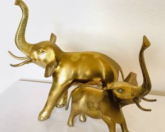 Pair of brass elephants, H 11" and H 13". Made in Korea. Slight patina finish on the trunks.