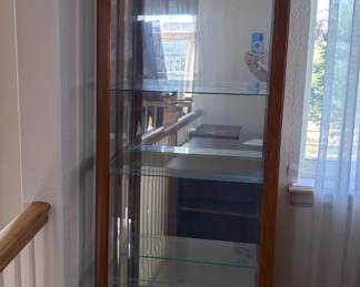 Pulaski Furniture Corp. Curio Cabinet. The cabinet is tantone with glass side and front windows, H 75" x W 21 1/2" x D 10 1/2", (4) glass shelves, doors open from the side. Interior light does not power on.