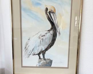Appears to be an original watercolor art piece featuring a pelican and signed by artist Kathleen J. Ritter. Double matted and metal frame. Art measures H 18" x W 13".