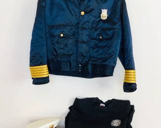 Fire chief satin bomber jacket, size 48R. Fire chief formal hat. Peterson AFB Fire Department crewneck sweatshirt, size XL. An assortment of meals and pins as shown in photos.
