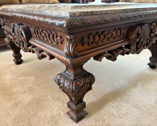 Appears to be a marble topped end table which features an intricately carved base. Made in China. H 27" x W 28" x D 28". Minor nicks and scratches. Matches lot 94. Receipt from consignor shows Ashley as the brand of furniture.