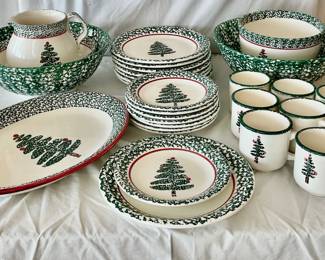 A large assortment of Furio Christmas tree themed dishware which includes (2) large serving bowls H 5" x 13" diameter (one has a chip on the side), (1) mixing bowl, (8) mugs, (1) pitcher, (1) serving platter (utensil markings) , (8) dinner plates, and (8) salad plates.