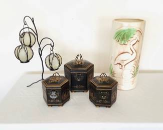 Oriental home accents which includes a set of (3) wooden boxes ranging in size from H 5" to H 6 1/2", a crane adorned large ceramic vase H 17 1/2" x 7" diameter, a tiered tea light holder, and a hand painted hummingbird egg with stand.