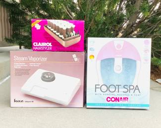 New in box Conair foot spa. Kaz steam vaporizer, model "Safeguard 285". Clairol Hair Styler heated rollers, power on.