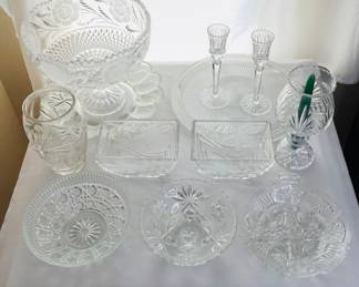 Crystal fruit bowl with crinkle edge and pedestal base, H 9" x 10" diameter. Hand cut (2) piece crystal candle holder, made in Hungary, H 8" x 5" diameter. Ralph Lauren "Safari" cut glass vase, H 7" x 5" diameter. Additional items include a pair of cut glass candle holders H 8", a glass deviled egg server and more. See photos for sampling.