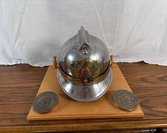 Commemorative Firefighter helmet, silver and gold tone, mounted, and two challenge coins - one from USAF and one from the Azores. See photos for details.