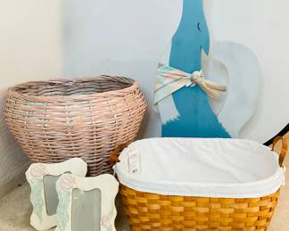 Wooden coyote figurine, H 37 1/2" x W 16" x D 5 1/2". Large basket with handles and liner made by Martha Stewart H 10" x W 22" x D 18". Large rattan basket, H 20" x 26" diameter. Two ceramic 5x7 picture frames.
