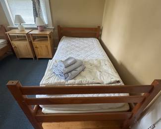 set of twin bunk beds with mattresses