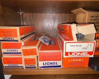 Vintage Lionel train cars and track in boxes