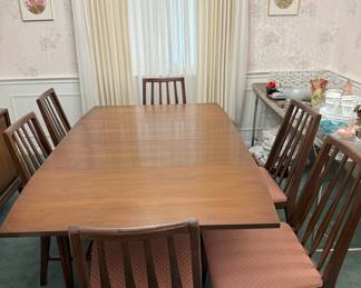 Dining Room drop leaf table with 3 leaves and table pads along with 6 chairs
