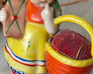 LOT 349 VINTAGE PIN CUSHION JAPAN FIGURINE PART OF A LARGER LOT W SEWING BASKET, ANOTHER PIN CUSHION & MISC