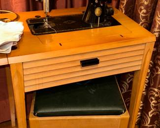 Singer machine inside a mid century cabinet 