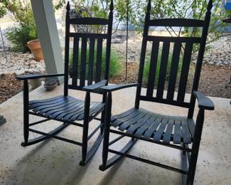 Pair of dark green rocking chairs