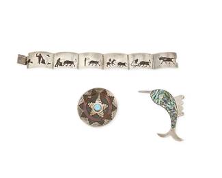 1180
A Group of Sterling Silver Jewelry
Comprising a Mexican sterling silver storyteller link bracelet with overlay/shadowbox bullfighting motifs, as well as a sterling silver and inset abalone swordfish brooch, and a Southwest Native American Navajo wedding basket motif round brooch, each marked for sterling
3 pieces
Bracelet: 7 in. x 7/8 in.; Pins: 3 in. & 1 3/4 in. Dia.
58.8 grams gross
Estimate: $300 - $500