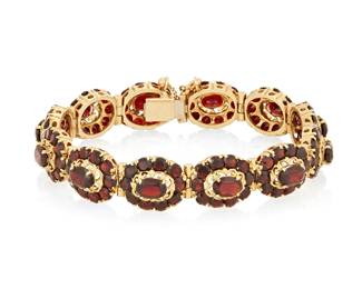 1077
A 14K Gold and Garnet Bracelet
Featuring foliate motif links set with round and oval garnets
Length: 7 1/2 in.
35.8 grams gross
Estimate: $1,200 - $1,800