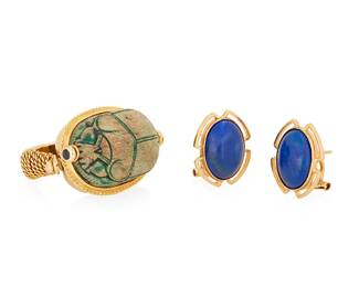 1127
A Group of 14K Gold and Hardstone Jewelry
One featuring a carved steatite scarab accented by round sapphires together with a pair of gold and oval lapis lazuli earrings
3 pieces
Earrings: 1/2 x 5/8 in., Ring: 8 1/4
24.6 grams gross
Estimate: $800 - $1,200