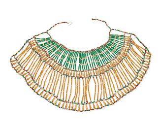 1165
An Egyptian Beaded Collar Necklace
A large latticework collar with tubular faience clay beads in green and yellow with gold-toned beads and multicolored clay bead spacers, all strung on wire and thread, 20th century
Measures: 18 1/2 in. x 7 1/4 in.
193.5 grams gross
Estimate: $500 - $700