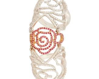 1061
An 18K Bi-Color Gold, Ruby and Diamond Ring
Of a flexible knuckle cover design featuring a three rose motif set with round diamonds and rubies
Size: 7 1/4 to 6
19.6 grams gross
Estimate: $1,500 - $2,000