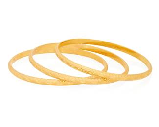 1049
A Group of Three Gold Bangles
Featuring ornate etched designs
3 pieces
Inner circumference: 8 1/4
35.5 grams gross
Estimate: $2,000 - $3,000