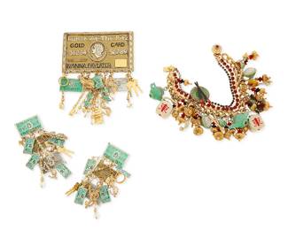 Back to catalog
1161
A Group of "Lunch at the Ritz" Costume Jewelry
Featuring gold-toned and mixed metal jewelry with multicolored enamel and diamanté accents comprising a chain link charm bracelet with multiple "Chinese Restaurant" motf charms including rice bowls, chopsticks and plates, teapots, fortune cookies, and take-away cartons, together with a set of credit card-themed "bling" jewelry comprising a large "Gold Card" pendant/brooch with luxury-themed dangles: gold keys, currency, and rings, and a pair of matching earrings
4 pieces
Bracelets: 8 in.; Earrings: 3 1/2 in.; Brooch: 5 in. x 3 1/2 in.
258.1 grams gross
Estimate: $200 - $400