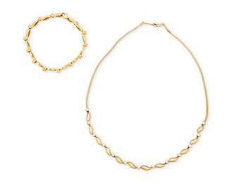 1108
Bravo: An 18K Gold Necklace and Bracelet Set
Featuring fluid open link designs accented by round diamonds weighing approximately 1.82 carats total, signed Bravo
2 pieces
Bracelet 7 1/4 in. Necklace: 16 in.
28.4 grams gross
Estimate: $1,500 - $2,000