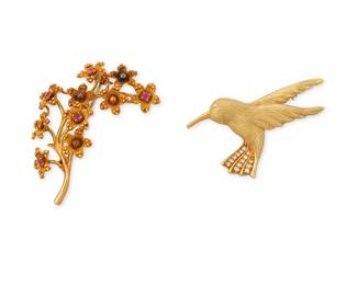 1050
Two 18K Gold Brooches
Including a Tiffany & Co. gold and ruby flower motif brooch together with a hummingbird brooch accented by round diamonds
2 pieces
Measures: 1 7/8 x 1 1/8 in., 2 x 1 in.
19.9 grams gross
Estimate: $800 - $1,200