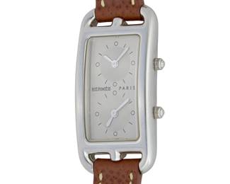1143
Hermès: A Cape Cod DuZone Wristwatch
Dial:rectangular with 2 dials featuring Diver hour markers
Model:Cape Cod CC3-210
Case number: 1739276
Signed: dial, case and clasp
Inner circumference: 6 1/2 in.
27.1 grams gross
Estimate: $800 - $1,200