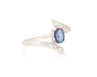 1052
An 18K White Gold, Sapphire and Diamond Ring
Centering an oval sapphire weighing approximately 0.90 carat accented by round and single-cut diamonds set in a bypass design
Size: 8 3/4
3.56 grams gross
Estimate: $1,500 - $2,000