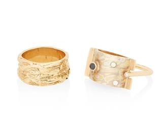 1126
Two 14K Gold and Silver Rings
One featuring an organic wave pattern, the other accented by round diamonds and a round sapphire cabochon set in a sterling half round top
2 pieces
Sizes: 7 3/4 and 9
24.0 grams gross
Estimate: $800 - $1,200