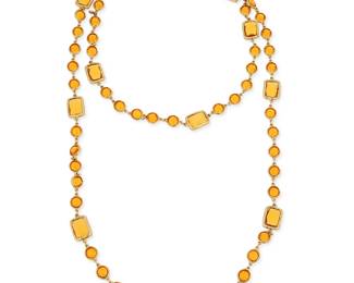 1152
CHANEL: A Gold Tone and Amber Glass "Chicklet" Necklace, 1981
Designed as a long chain featuring round and rectangular deep yellow glass links, signed on charm: Chanel, double C, 1981
Length: 57 in.
167.0 grams gross
Estimate: $1,500 - $2,000