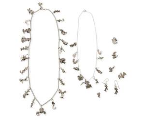 1176
A Group of Sterling Silver Charm Jewelry Including Disney
Comprising two chain charm necklaces with thirty-three various diminutive sterling silver Disney charms including Mickey Mouse, Cinderella, Snow White, Ariel, Pluto, Donald Duck, Winnie the Pooh, Piglet, Tigger, and Dumbo, together wit ha pair of Mickey Mouse charm earings, and five further single charms including a bat, a cat, and squirrels
9 pieces
Necklaces: 24 in & 18 in.; Earrings: 1 1/2 in.; Charms: 1 in. - 3/4 in.
164.4 grams gross
Estimate: $300 - $500