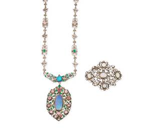 1178
Two Silver and Opal Jewelry Items
Comprising a delicate ornate filigree sterling silver pendant necklace with set opals, one a doublet, and one a large cabochon with color variation, and pink and green gemstones, with bird and floral motifs, (marked G verso), as well as a silver and set opal filigree brooch
2 pieces
Necklace: 24 in. x 2 3/4 in.; Brooch: 2 1/4 x 1 7/8 in.
51.0 grams gross
Estimate: $600 - $800