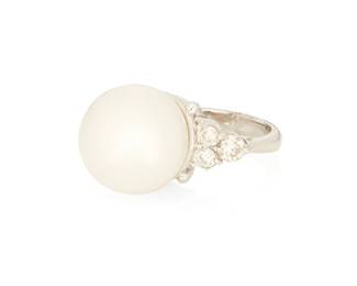 1026
An 18K White Gold, Cultured Pearl and Diamond Ring
Centering a cultured pearl measuring approximately 13.60 mm, accented by six round diamonds weighing approximately 0.36 carat
Size: 5 1/4
8.58 grams gross
Estimate: $700 - $1,000