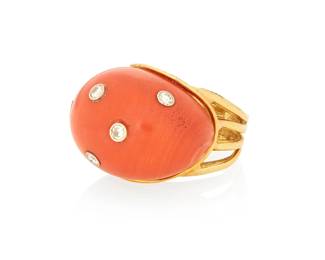 1008
A 14K Gold, Coral and Diamond Ring
Centering an organic shaped coral cabochon, accented by five round diamonds
Size: 4 1/4
13.4 grams gross
Estimate: $600 - $800