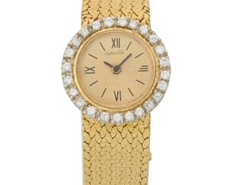 1140
Laykin et Cie: A Gold 14K Gold and Diamond Wristwatch
Dial: 15.77 mm, round with Roman Numeral hour markers, encircled by round diamonds weighing approximately 0.72 carat
Closure: textured gold woven bracelet with a jewelry clasp
Inner circumference: 6 1/4 in.
34.9 grams gross
Estimate: $1,000 - $1,500