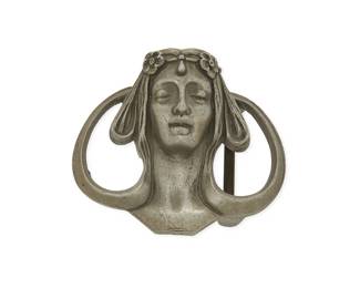 1183
A SandyVal Pewter Art Nouveau-style Belt Buckle
A portrait buckle depicting a woman's face with stylized hair and floral circlet, with marks verso: SandyVal / Pewter / 1971
Measures: 3 1/4 in. x 3 5/8 in.
137.6 grams gross
Estimate: $100 - $200