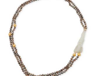 1029
An 18K Gold, Cultured Pearl and Jade Necklace
Of a two-strand design featuring brown cultured pearls, highlighting a large carved jade element with a monkey motif, finished with 18k gold granulated beads
Length: 37 in, Jade: 4 x 1 in.
146.31 in.
Estimate: $1,000 - $2,000