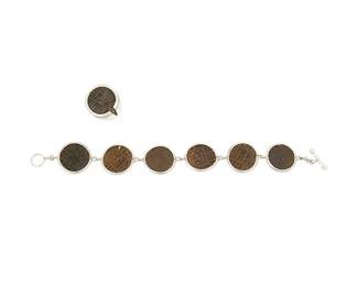 1181
A Set of Sterling Silver and Ancient Coin-style Jewelry
Featuring a mixed metal coin link bracelet with toggle clasp, together with a matching chunky coin ring
2 pieces
Bracelet: 8 in.; Ring: size 10 1/2
56.2 grams gross
Estimate: $400 - $600