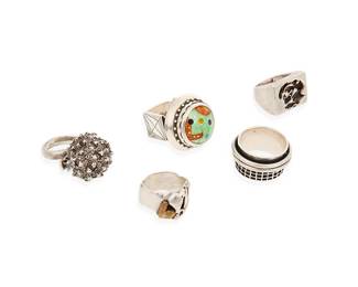 1187
A Group of Sterling Silver Rings
Comprising five modernist-style rings in various designs and sizes including one with a multicolored enamel "cabochon" dome top, one in the form of a seed pod, and one with abstract figures in silver and copper overlay
5 pieces
Rings: sizes 12 to 7 1/2
119.9 grams gross
Estimate: $700 - $900