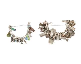 1177
Two Sterling Silver Charm Bracelets
Comprising a chunky sterling silver chain bracelet with multiple sterling souvenir and auspicious charms including the Colosseum, the Bocca della Verità in Rome, a windmill, an oil lamp, a bull, a prayer wheel, a seashell, a tankard, a Mayan calendar, a quiver with arrows, and more, as well as a smaller bracelet with various enamel and figural charms from New Zealand, the South Pacific and the western USA
2 pieces
Lengths: 6 1/2 in. to 6 1/4 in.
214.5 grams gross
Estimate: $1,000 - $2,000