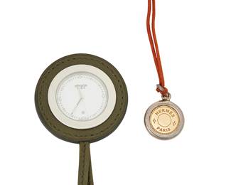 1144
Hermes: A Pocket Watch and Pendant Necklace
Including a leather pocket watch, no. 2682744 signed Hermes Paris together with a silver, plated and cord necklace signed Hermes Paris
2 pieces
Watch: 34 in., Necklace: 26 in.
Estimate: $700 - $900