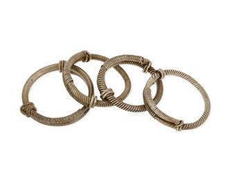 1189
A Group of Sterling Silver and Mixed Metal Bangles
Comprising four heavy twisted wire-wrapped handmade bangles, three in sterling silver, and one of six-sided silver metal wire with stamping
4 pieces
Largest: 8 1/4 in. inner C x 3/4 in.; smallest: 7 1/2 in. inner C x 3/4 in.
552.2 grams gross
Estimate: $200 - $400
