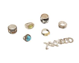 Back to catalog
1188
A Group of Sterling Silver and Gemstone Jewelry
Comprising a Paloma Picasso for Tiffany & Co "XXXOOO" sterling silver brooch, circa 1983, together with six rings in various designs including David Yurman sterling and 18K gold ring with buckle detail, a Pianegonda sterling silver and black enamel "hearts" band, an Anita Selinger sterling and 8K gold ring with set peridot, a sterling rope-twist ring with set sapphires, a wide abstract sterling and 18K gold band with set rubies, and a small Southwest silver ring with set chunky turquoise
7 pieces
Rings: sizes 6 1/2 to 1 1/2; Brooch: 3/4 in. x 2 3/4 in.
68.3 grams gross
Estimate: $500 - $700