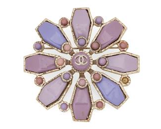 1151
CHANEL: A Vintage CC Purple Floral Pendant Brooch, 2004
A stylized floral brooch/pendant in silver-toned metal with various colored purple faux stones, signed to plaque: Chanel; Made in France; 04 / P
Measures: 2 1/2 in Dia.
41.7 grams gross
Estimate: $600 - $800