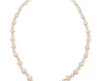 1017
An Opal and Rock Crystal Quartz Necklace
Featuring a single strand of graduated opal beads measuring approximately 6.0-10.9 mm, accented by faceted rock crystal quartz beads measuring approximately 5.9 mm, finished with a platinum and diamond set clasp
Length: 23 in.
32.5 grams gross
Estimate: $500 - $700